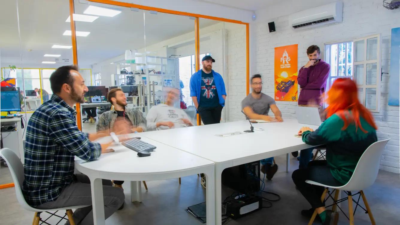 People in an office having a meeting and enjoying themselves